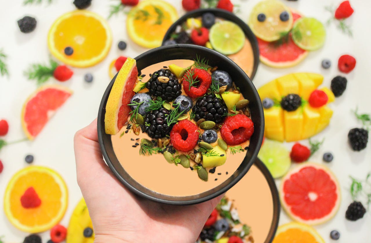 Colorful bowl of fresh fruits with a mix of berries and seeds, perfect for a healthy meal.